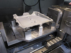 The workpiece does not need to be flat, as the adhesive conforms to the shape of the workpiece.