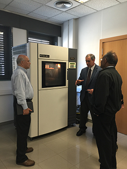 Penn State faculty members Sanjay Joshi and M. Jeya Chandra are shown one of the 3D printers at the Institut Quimic de Sarria in Spain