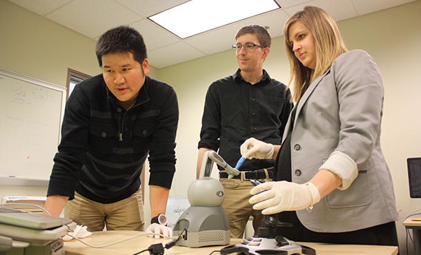 Inki Kim, Scarlett Miller and Jason Moore demonstrate use of robot