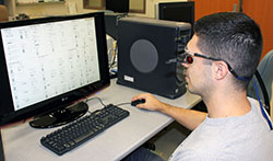 Industrial engineering graduate student Ben Noah uses the eye tracker to evaluate the effectiveness of shapes in the monitoring of a crude oil distillation process.