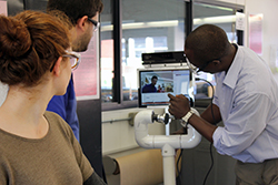 NSF National Robotics Initiative Principle Investigator Conrad Tucker calibrates the data acquisition functionality of co-robot Pennie's sensing system.