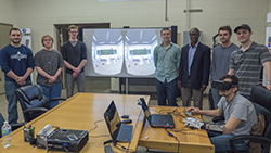 The Oculus Rift team. From left to right: Kevin Lesniak, Matthew Myers, Daniel Ahrweiler, Bryan Dickens, Conrad Tucker, Gabe Harms, Steven Sellers and Owen Shartle (who is wearing the Oculus Rift headset and glove).