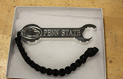 The front side of a bottle opener/wrench made in the Factory for Advanced Manufacturing Education within the Harold and Inge Marcus Department of Industrial and Manufacturing Engineering for Military Appreciation Day donors. 