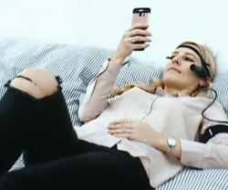 Woman lying down using a smartphone