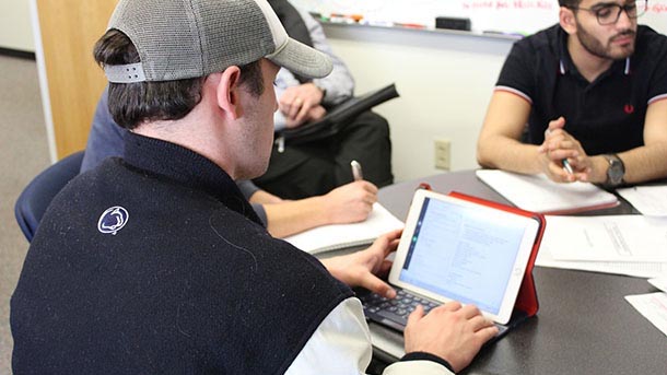 Industrial engineering students meeting with Fleet Services employees about their difficulties scheduling vehicles.