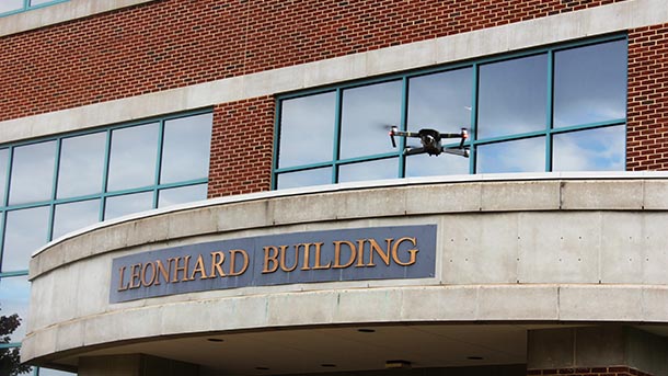 A drone hovers about the Leonhard Building. 