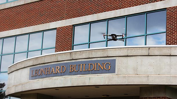 A drone hovers about the Leonhard Building.