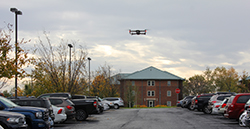 The drone capturing footage of a parking lot outside of Leonhard Building. 