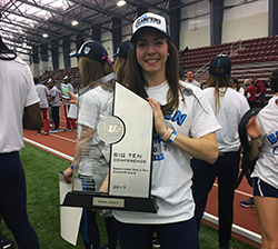 DeCecco holds the 2017 Big Ten Championship trophy for indoor track & field