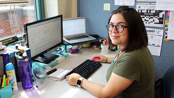 Barbara Venegas sits at her desk in the optimization lab in Leonhard Building