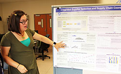 Venegas explaining her most recent optimization project using a research poster