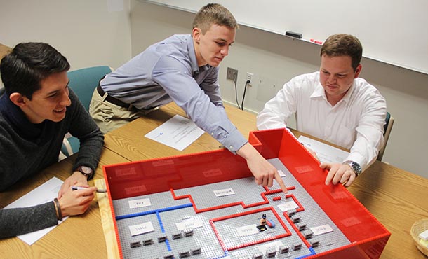 Sergio Viscarra, Jabel Warren and Steven Prigg present their team’s LEGO model of the proposed floor layout to the ENCS inventory team at a status meeting this semester. 