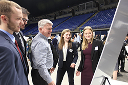 The group of industrial engineering students that worked on the fall 2017 project for ENCS, including John Haugen (far left) and Katie Heininger (far right), along with their adviser, Charlie Purdum, at the Engineering Design Showcase in November.