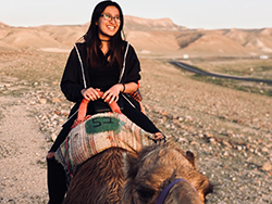 Chemical engineering student Trisca Ngo gets a lift over the dunes of Negev Desert 