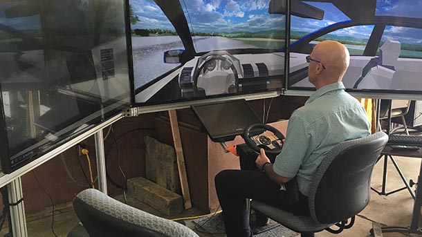 man using a highway driving simulator